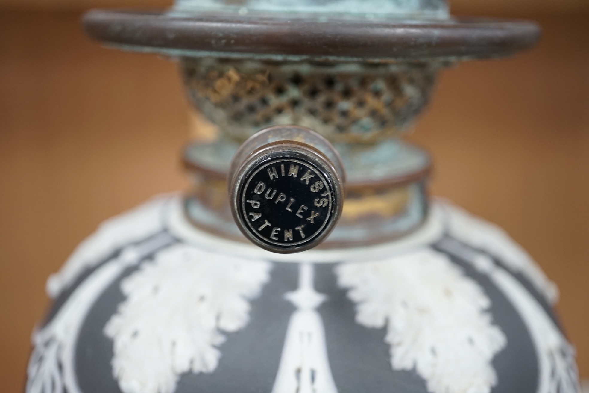 A Victorian black jasper oil lamp and reservoir, 65cm high. Condition - repaired at stem